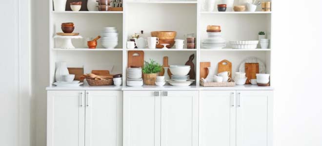 white shelving unit filled with kitchen essentials